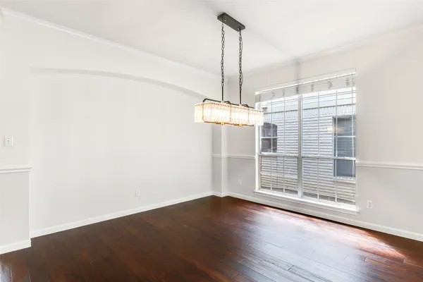 a view of a room with wooden floor closet and windows