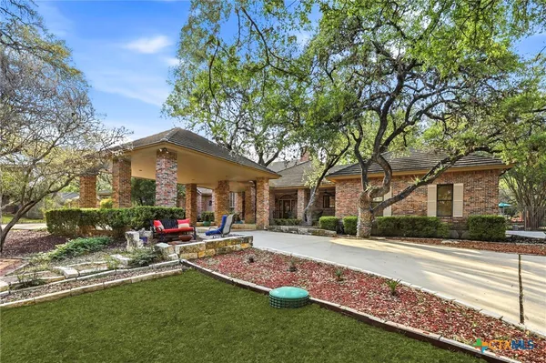 a front view of house with yard and trees around