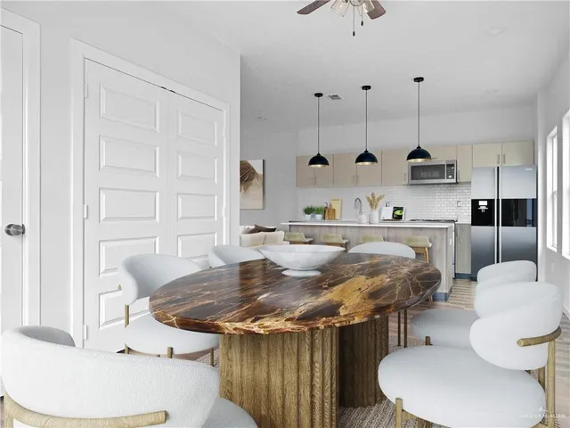 a kitchen with a table chairs and a wooden floor