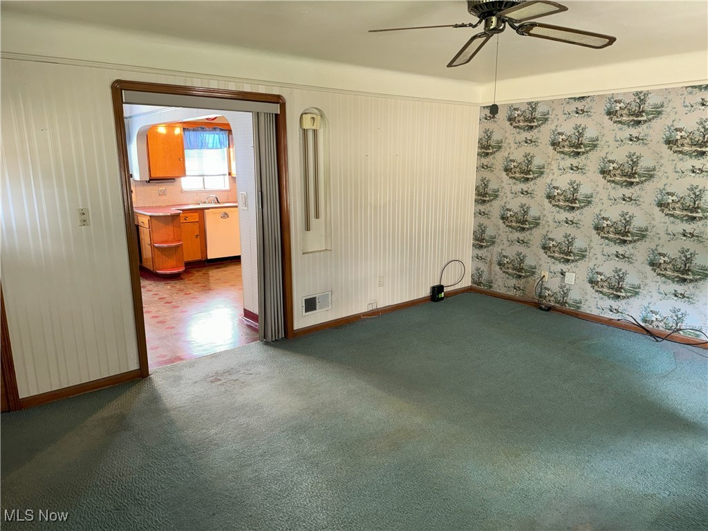 6271 Holburn Road Parma, OH 44129 - Photo 7 of 17 Empty room featuring ceiling fan, sink, and dark tile patterned floors