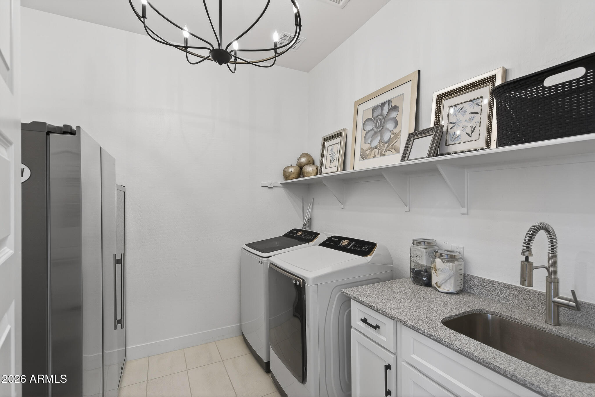 20627 West Rancho Drive Buckeye, AZ 85396 - Photo 28 of 82 a kitchen with stainless steel appliances a sink a refrigerator and cabinets