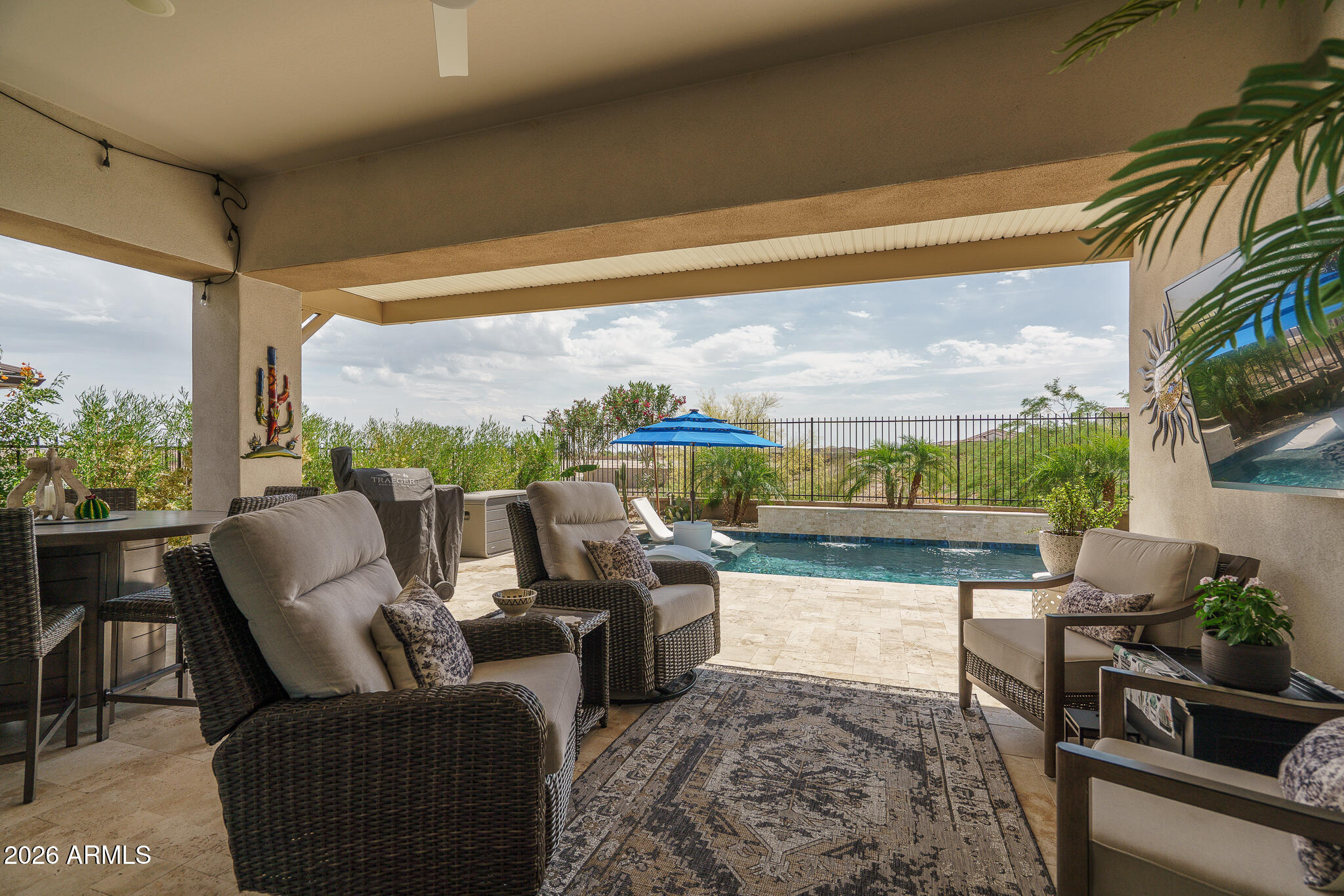 20627 West Rancho Drive Buckeye, AZ 85396 - Photo 29 of 82 a living room with patio furniture and a floor to ceiling window