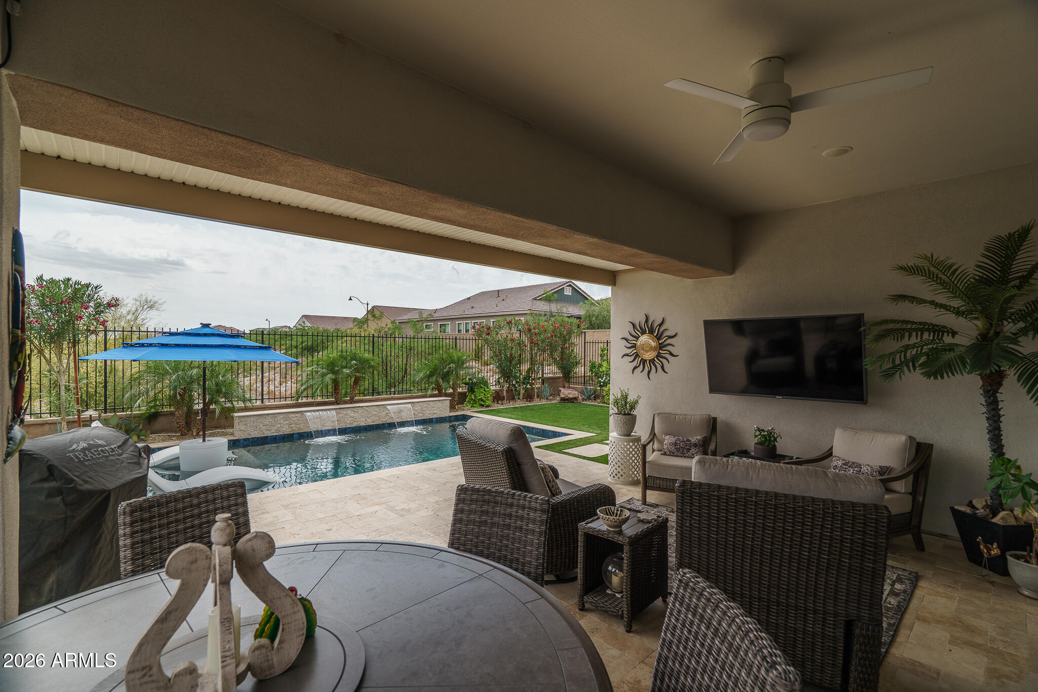 20627 West Rancho Drive Buckeye, AZ 85396 - Photo 31 of 82 a living room with furniture a flat screen tv and a floor to ceiling window