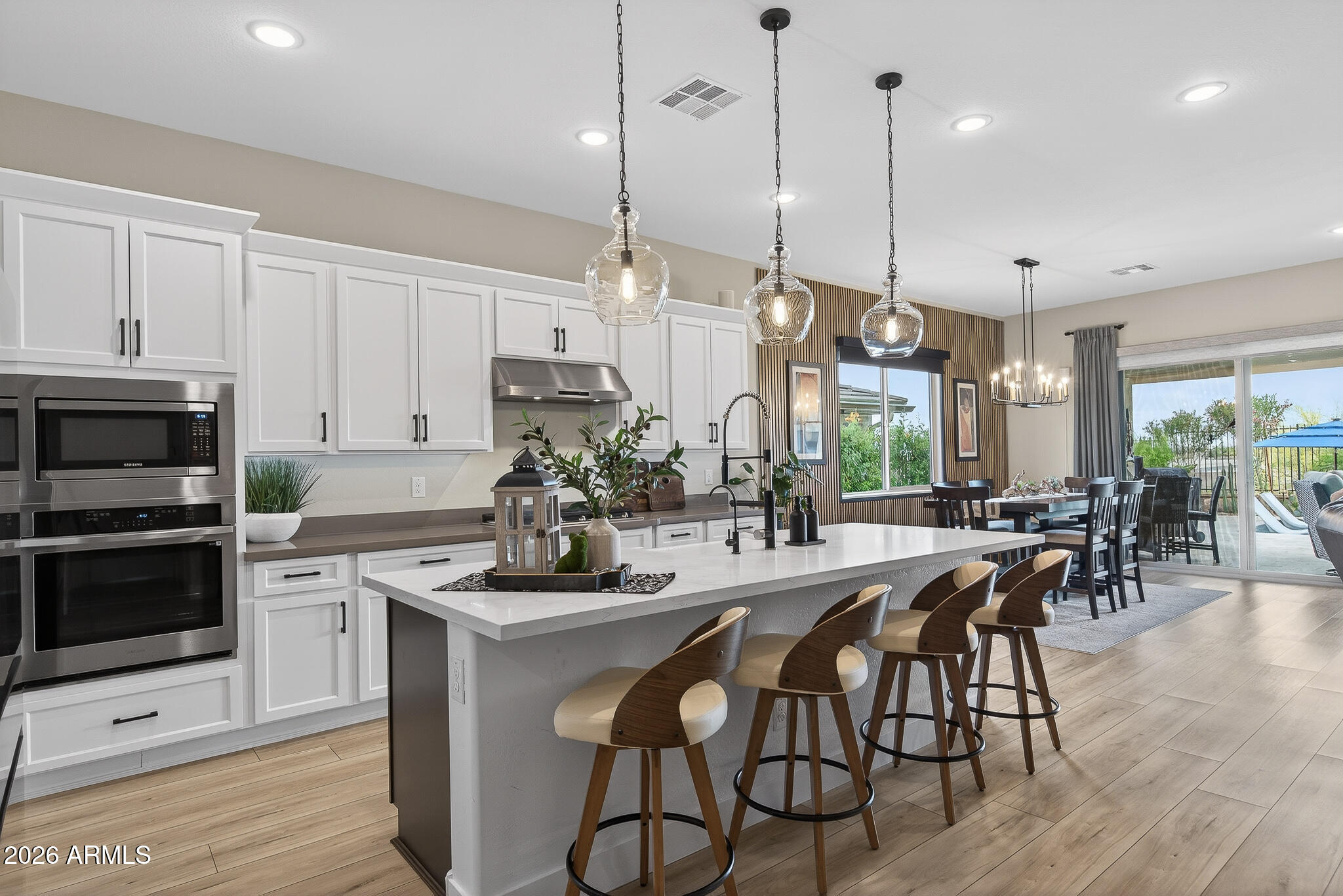 20627 West Rancho Drive Buckeye, AZ 85396 - Photo 8 of 82 a kitchen with stainless steel appliances kitchen island a large island in the center and cabinets