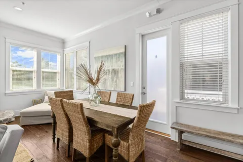 a view of a dining room with furniture and a window