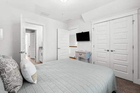 a bedroom with a bed and a flat screen tv