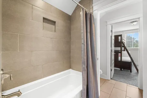 a en suite bathroom with a bathtub and a shower