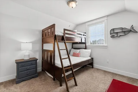 a bedroom with furniture and a window