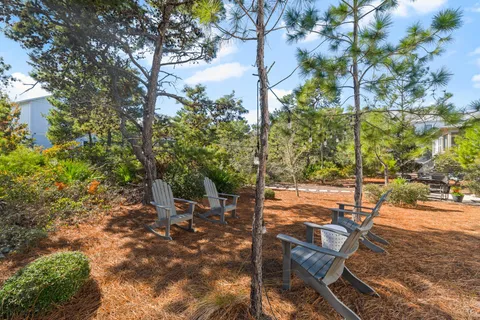 a view of a patio with table and chairs and potted plants