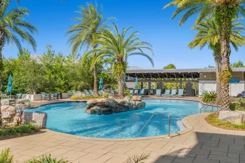 an aerial view of a house with swimming pool and a yard