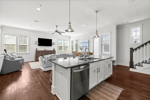 a kitchen with stainless steel appliances granite countertop a stove and a wooden floors