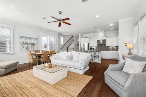 a living room with furniture and a wooden floor