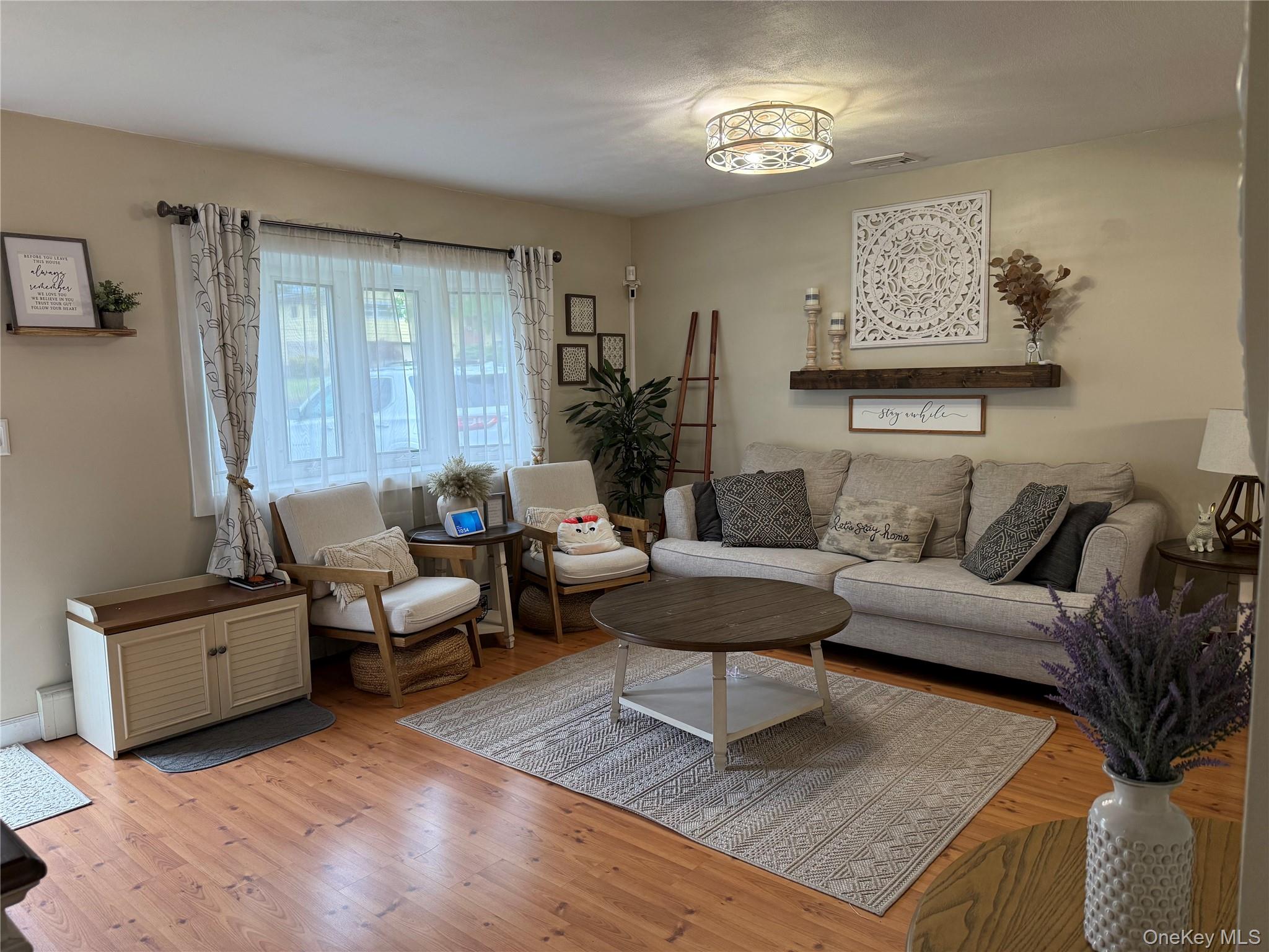 161 Hawkins Road Centereach, NY 11720 - Photo 3 of 16 a living room with furniture and a window