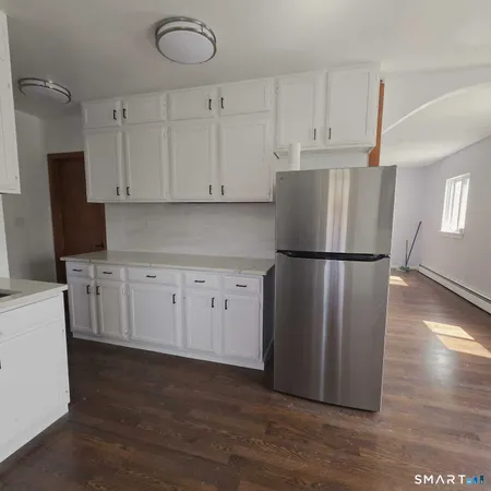 a kitchen with cabinets and stainless steel appliances
