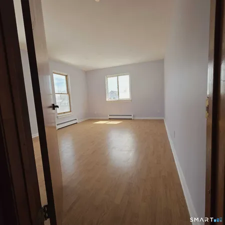 a view of a room with wooden floor and staircase