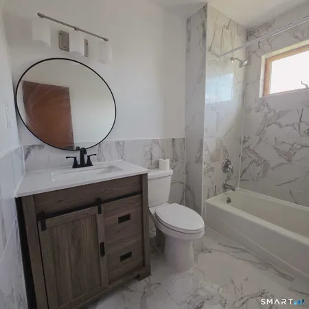 a bathroom with a sink a toilet and a mirror
