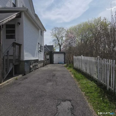 a backyard of a house with wooden fence