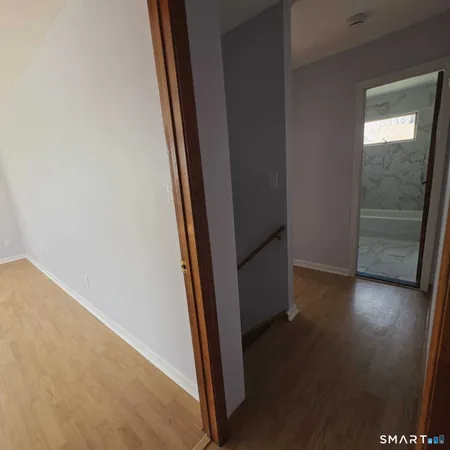 an empty room with wooden floor