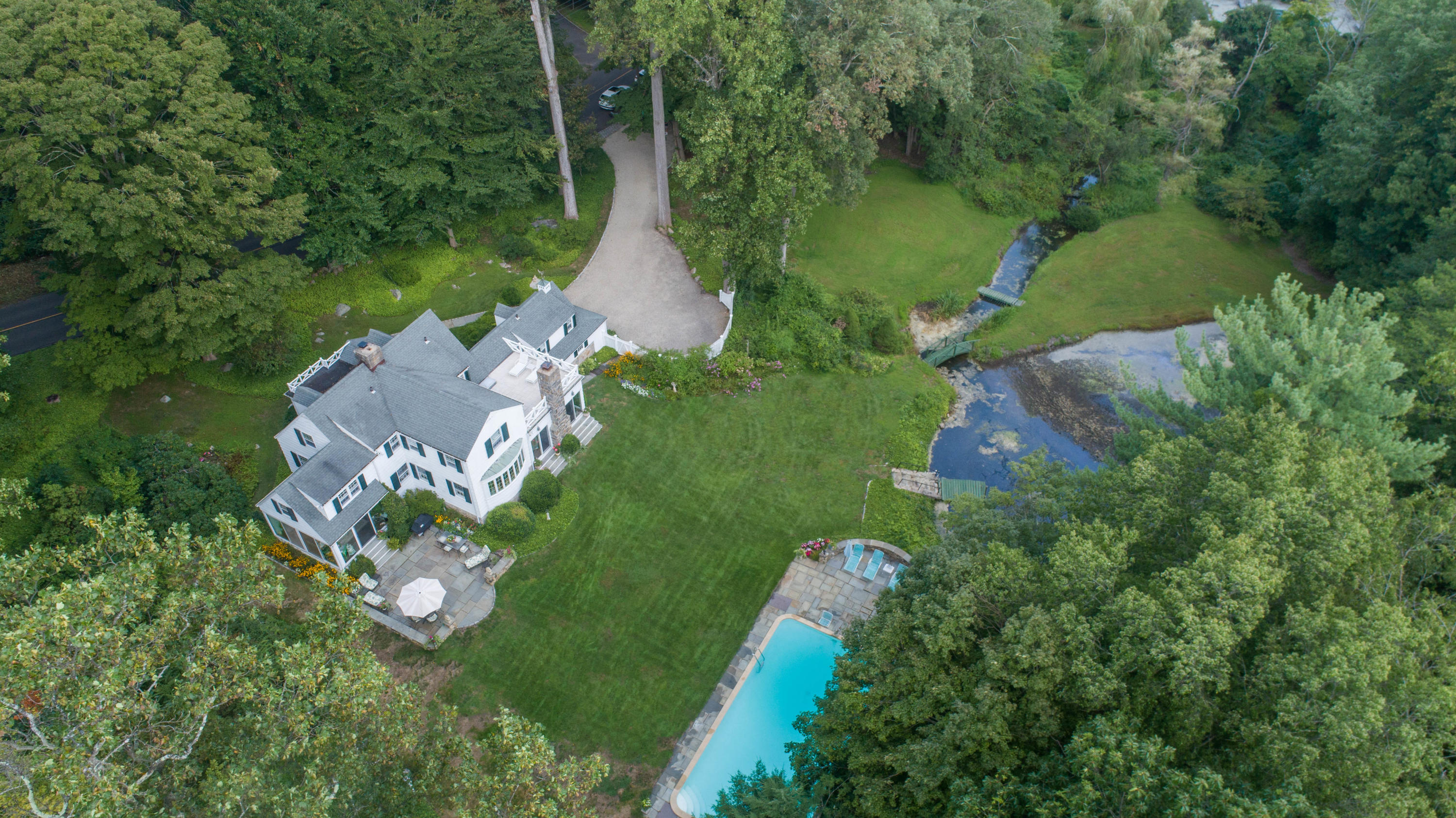 211 Laurel Road New Canaan, CT 06840 - Photo 1 of 47 aerial view of a house with a yard and lake view