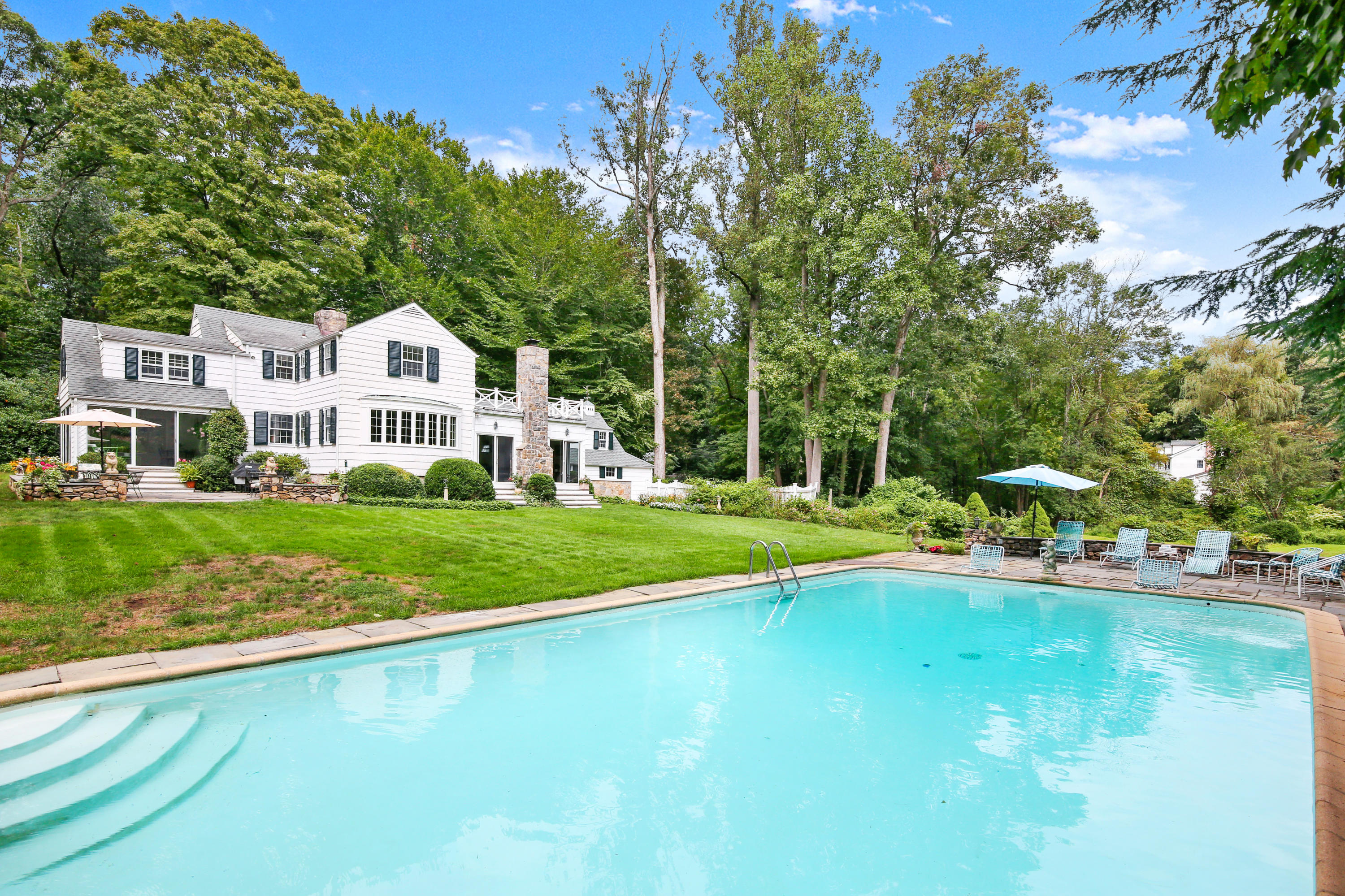 211 Laurel Road New Canaan, CT 06840 - Photo 2 of 47 a view of a house with a big yard and large trees