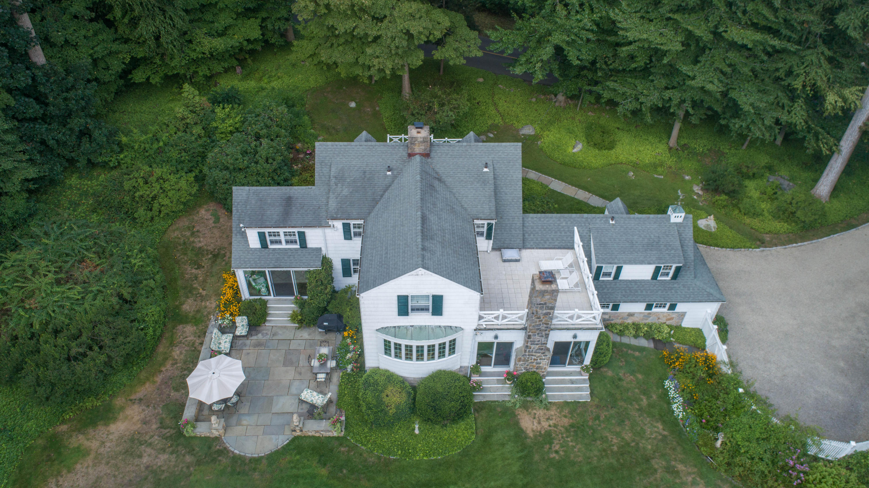 211 Laurel Road New Canaan, CT 06840 - Photo 4 of 47 an aerial view of a house with a garden