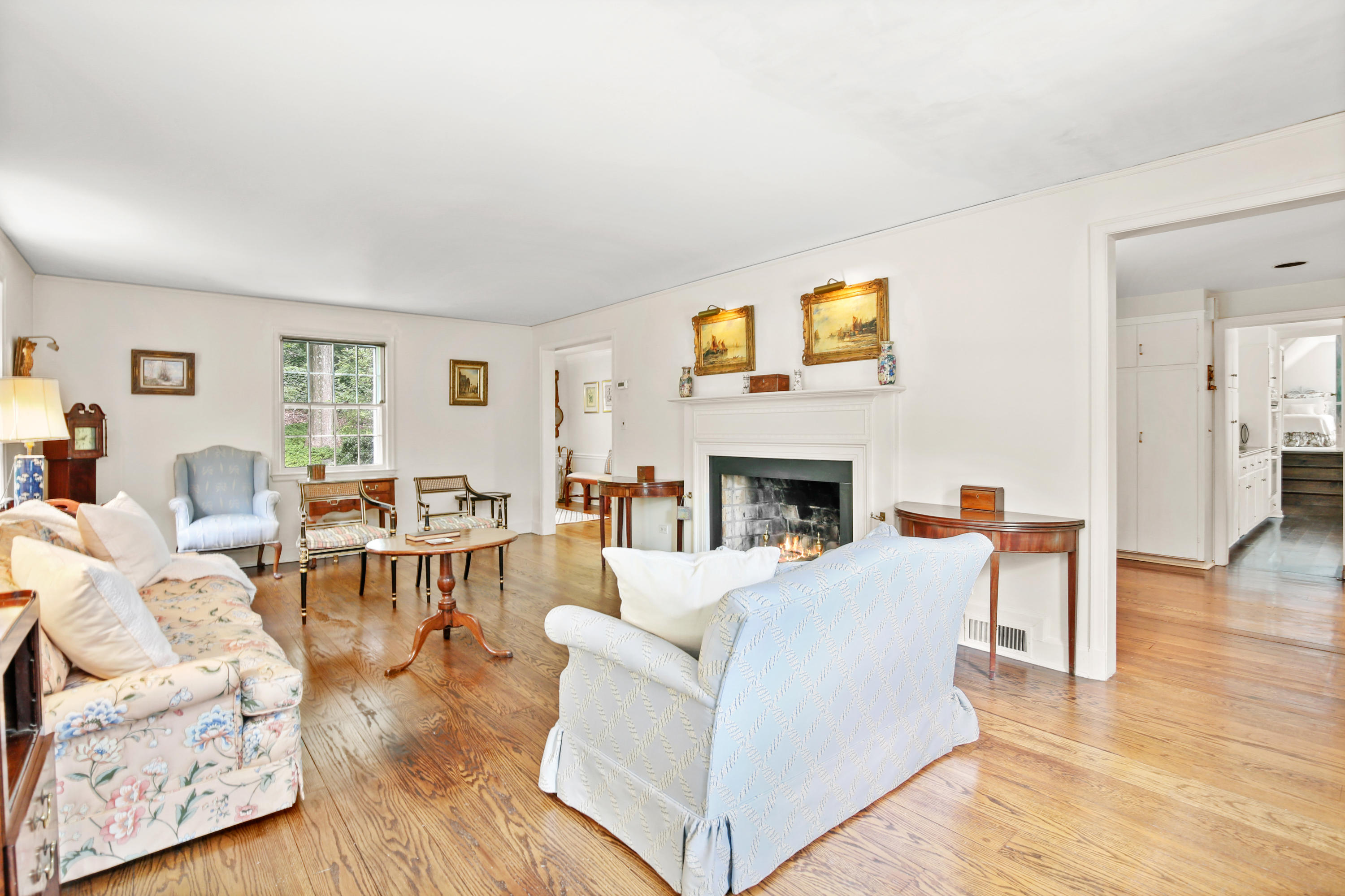 211 Laurel Road New Canaan, CT 06840 - Photo 10 of 47 a living room with furniture a fireplace and a wooden floor