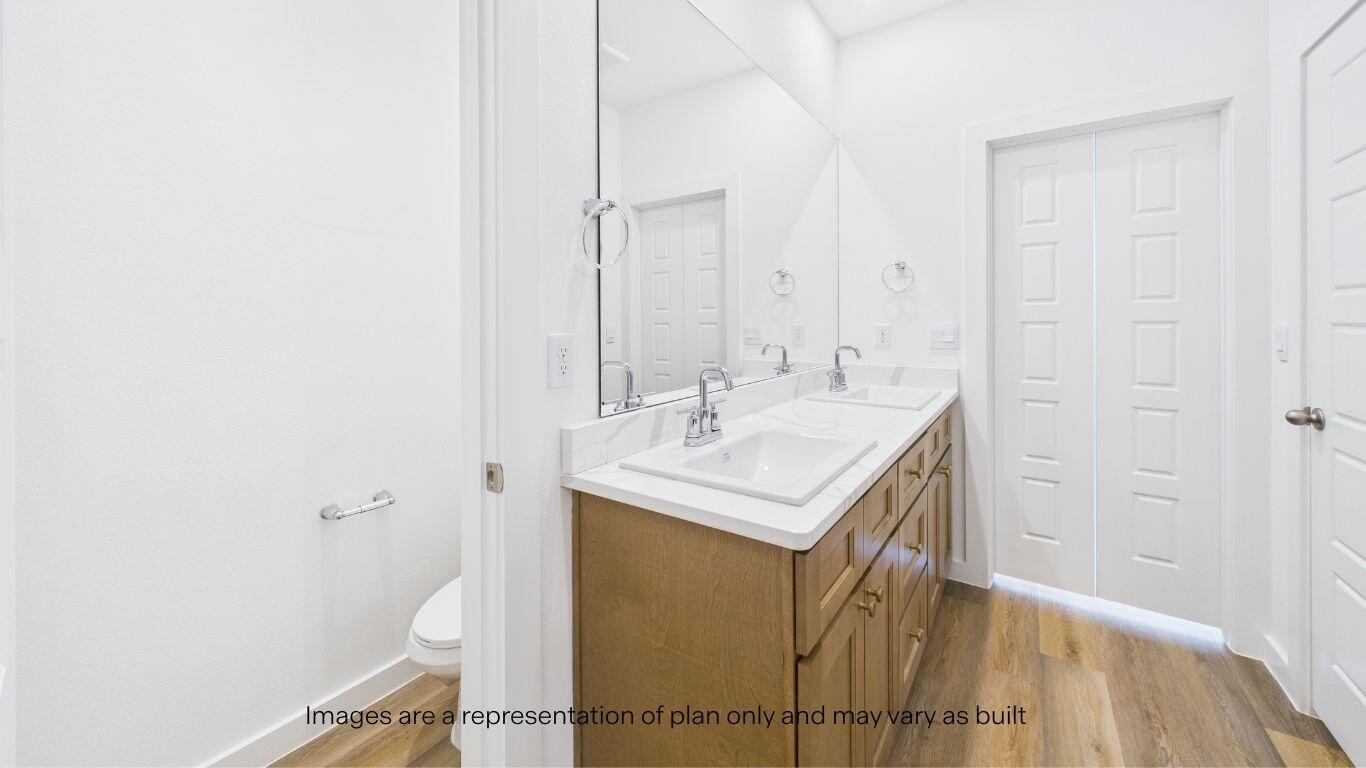 2812 134th Street Lubbock, TX 79423 - Photo 19 of 36 a bathroom with a sink a toilet and a mirror