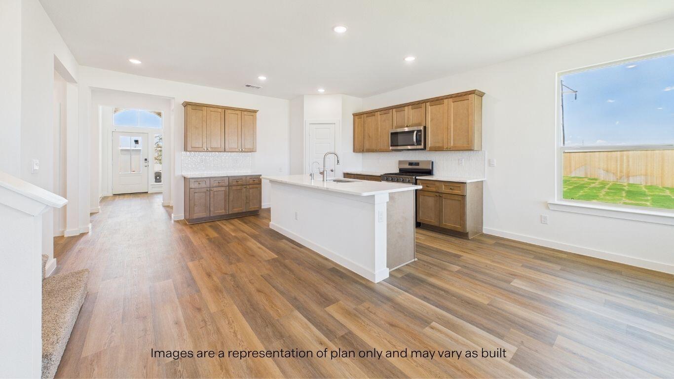 2812 134th Street Lubbock, TX 79423 - Photo 7 of 36 a kitchen with stainless steel appliances a stove top oven a sink dishwasher and a refrigerator with wooden floor