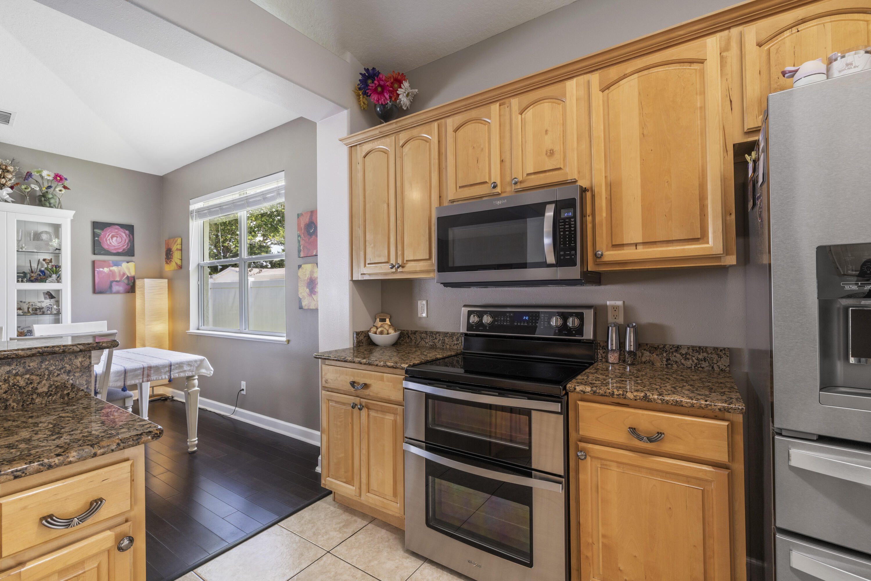 110 Briarcliff Circle Sebastian, FL 32958 - Photo 12 of 42 a kitchen with granite countertop a stove top oven microwave and cabinets