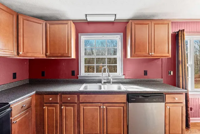 a kitchen with granite countertop cabinets and window