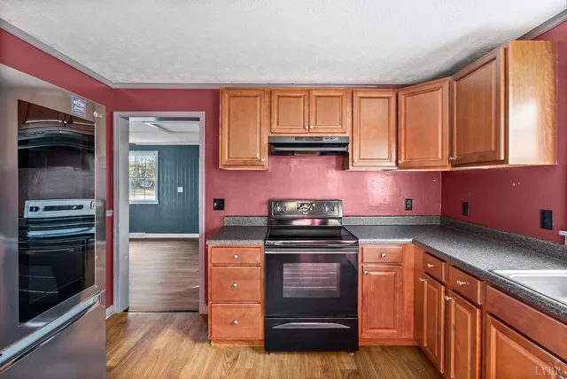 a kitchen with stainless steel appliances granite countertop a stove and a sink