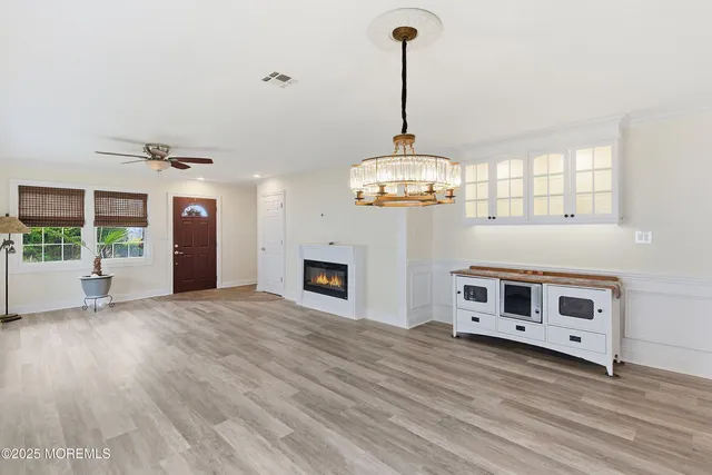 a view of a livingroom with a fireplace a ceiling fan and fireplace
