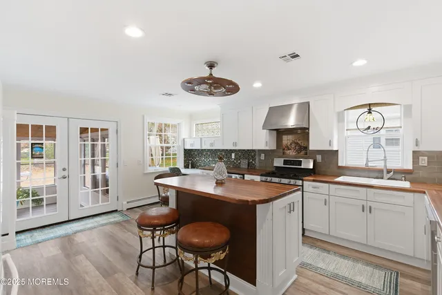 a kitchen with stainless steel appliances a stove a sink and a refrigerator