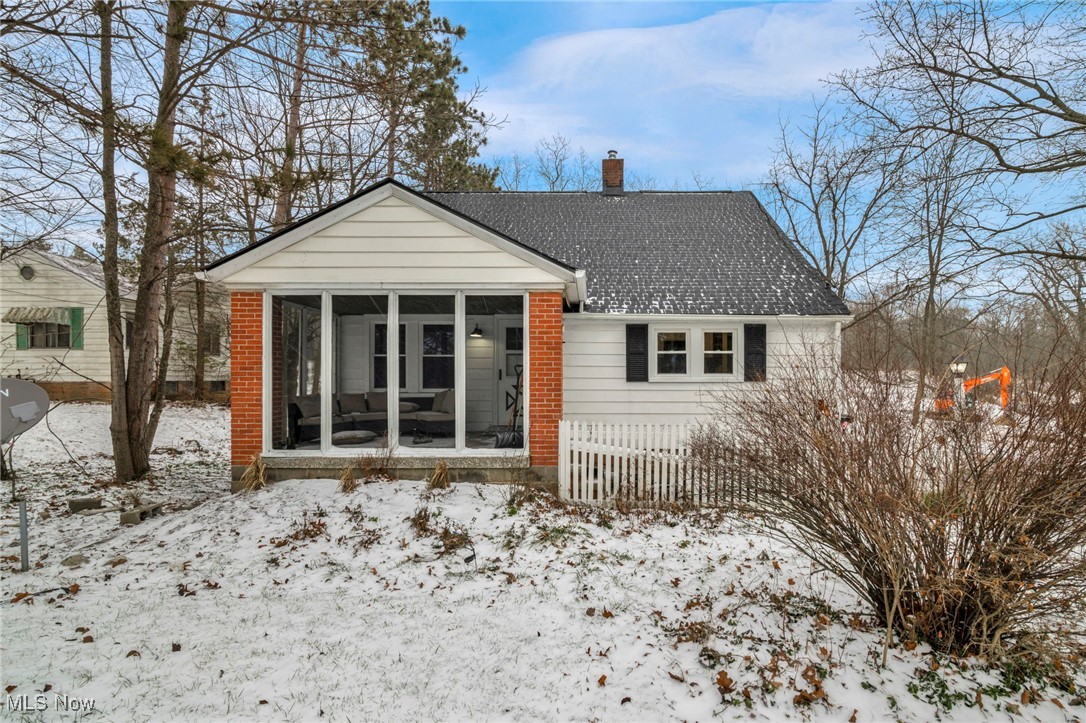 Front of home w/ramp, two entrances (front & side) paved driveway, 2 car detached garage