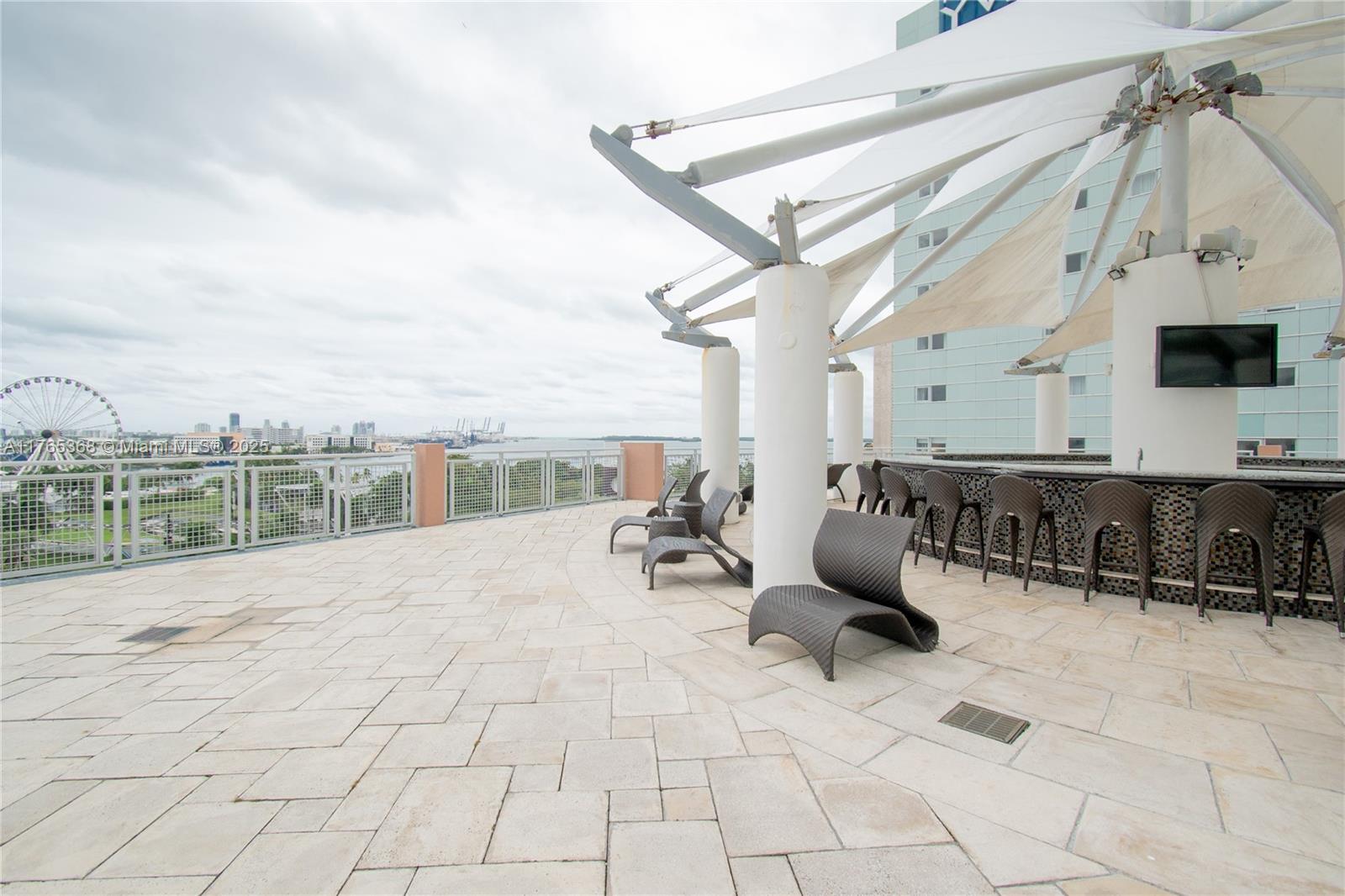Miami Central Business District Miami, FL 33132 - Photo 16 of 23 a building outdoor space with patio furniture and mountain view