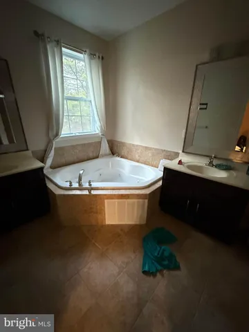 a bathroom with a bathtub sink and window