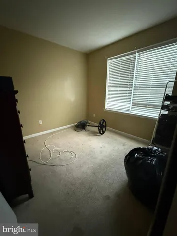a view of a room with gym equipment and windows