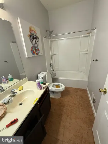 a bathroom with a sink mirror toilet and bathtub