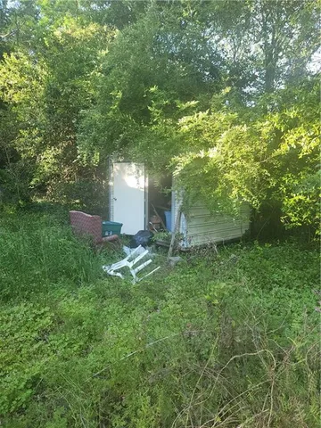a backyard of a house with lots of green space and garden view