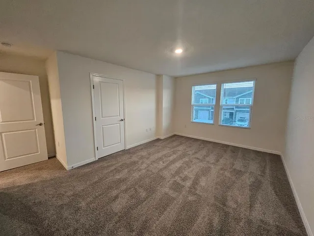 a view of an empty room and a window