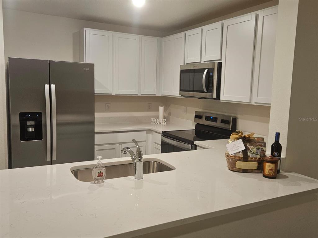 6577 Southwest 81st Loop Ocala, FL 34476 - Photo 9 of 25 a kitchen with stainless steel appliances granite countertop a refrigerator and a sink