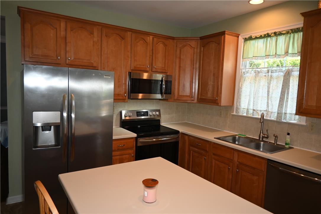 3829 East Hopewell Road Center Valley, PA 18034 - Photo 15 of 52 A well-equipped kitchen features a suite of stainless steel appliances and abundant wood cabinetry for storage.
