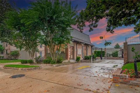 a pathway of a house with a yard