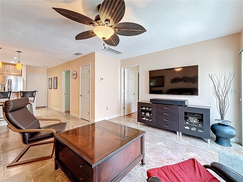 230 Medallion Boulevard, Unit G Madeira Beach, FL 33708 - Photo 15 of 44 a living room with furniture and a flat screen tv