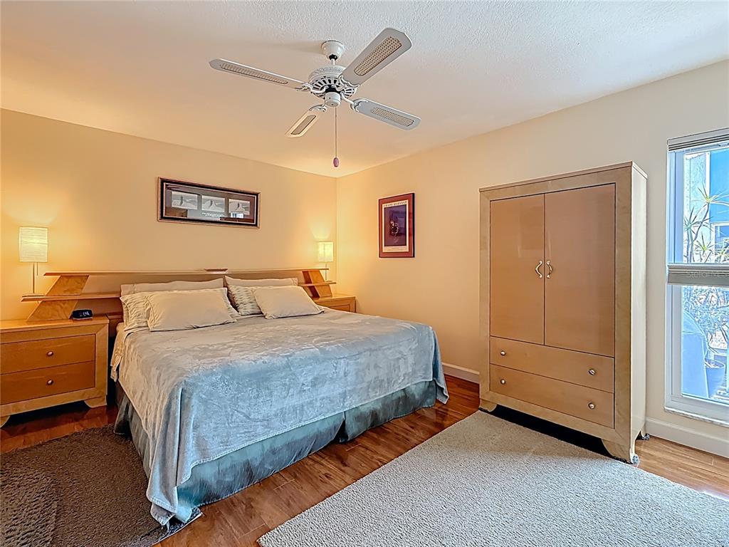 230 Medallion Boulevard, Unit G Madeira Beach, FL 33708 - Photo 16 of 44 a spacious bedroom with a bed and a window