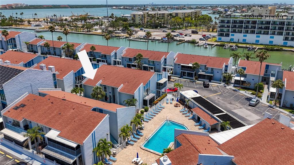 230 Medallion Boulevard, Unit G Madeira Beach, FL 33708 - Photo 2 of 44 an aerial view of a house with a lake view