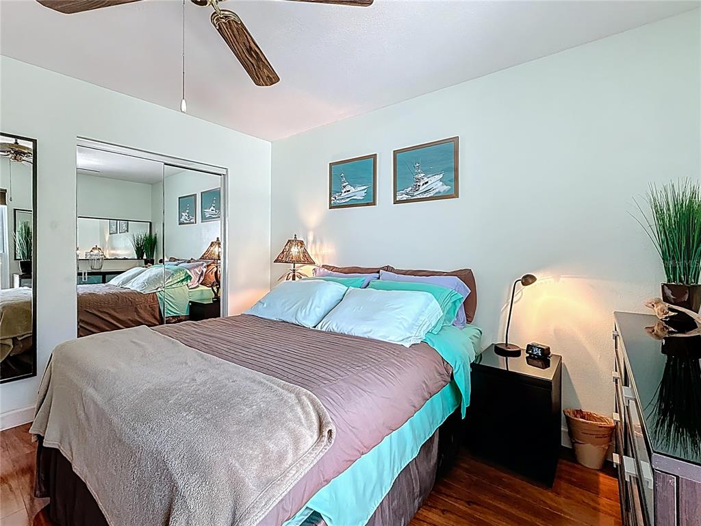 230 Medallion Boulevard, Unit G Madeira Beach, FL 33708 - Photo 21 of 44 a bedroom with a bed and a flat tv screen on dresser