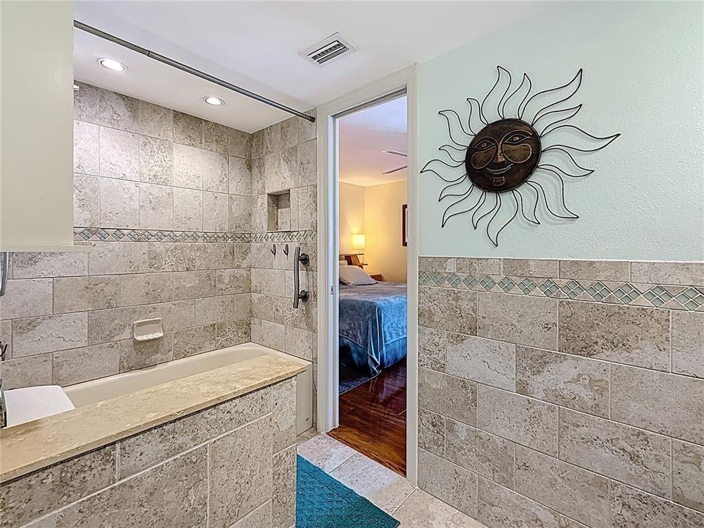 230 Medallion Boulevard, Unit G Madeira Beach, FL 33708 - Photo 25 of 44 a bathroom with a sink a toilet and shower