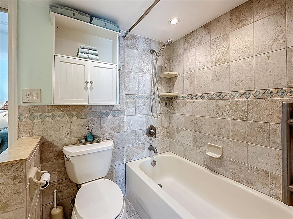 230 Medallion Boulevard, Unit G Madeira Beach, FL 33708 - Photo 26 of 44 a white toilet sitting next to a bath tub