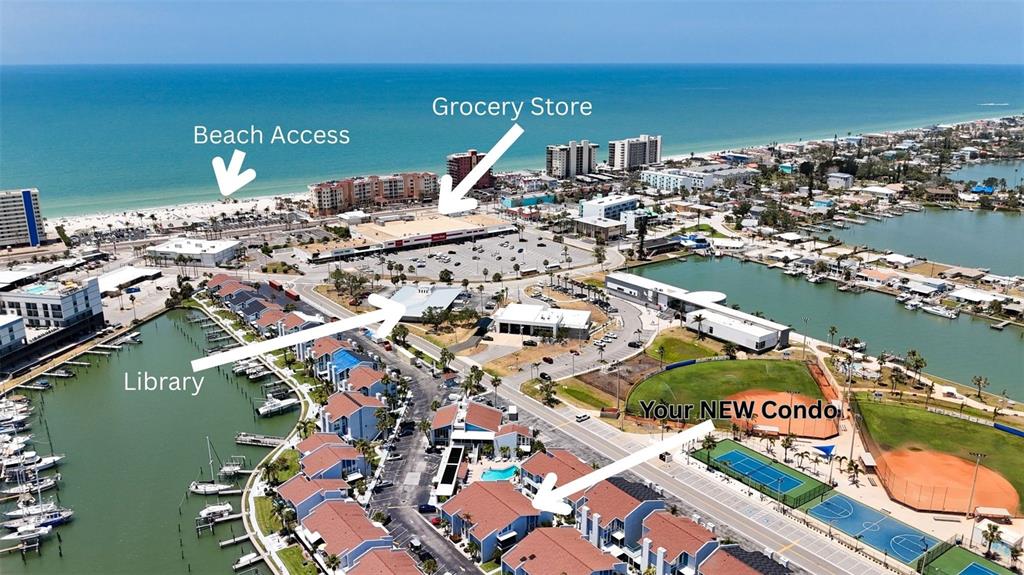 230 Medallion Boulevard, Unit G Madeira Beach, FL 33708 - Photo 3 of 44 an aerial view of a city with ocean view